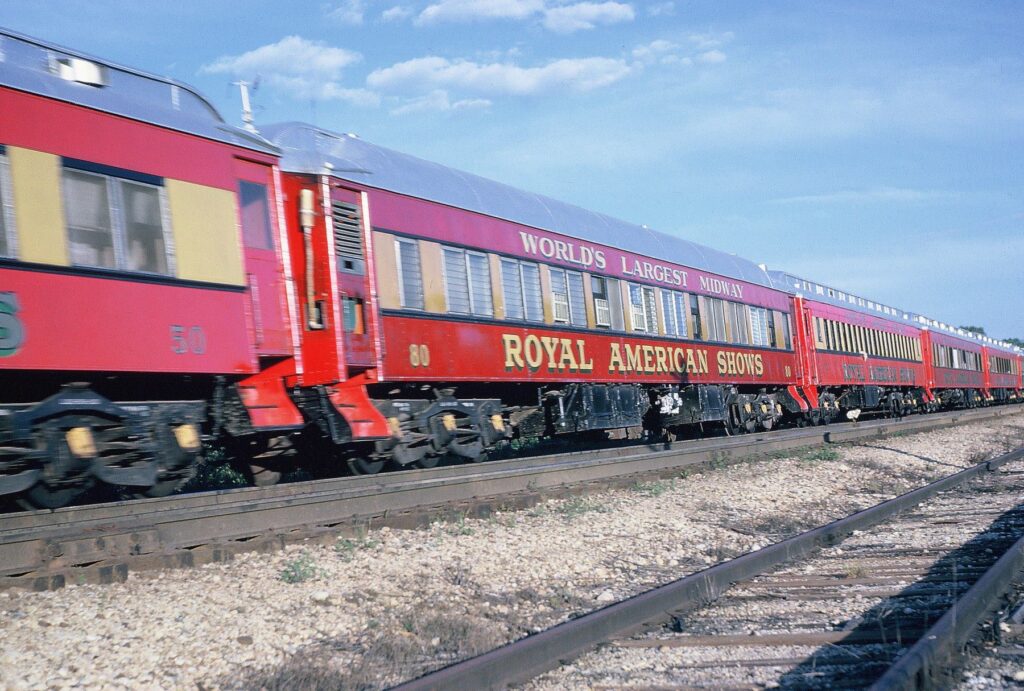 alt=Railroad Trains loaded with colorful wagons